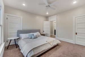 Carpeted bedroom featuring ceiling fan