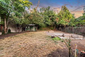 Yard at dusk with a shed