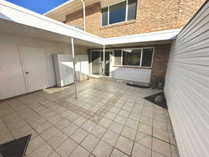 Beautiful Tiled Patio Off Dining Area - Don't Miss The Storage Cabinets  with lots of shelves on the left! Plus just on this side of them is a built in Storage closet with shelves and open space for tools and outdoor materials, folding chairs and tables,