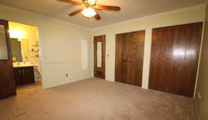 Primary bedroom featuring ornamental molding, and ceiling fan