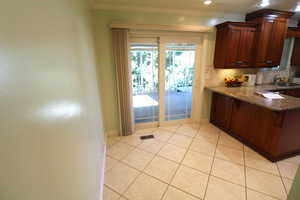 Dining area with light tile patterned floors