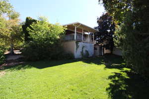 View of yard featuring a balcony