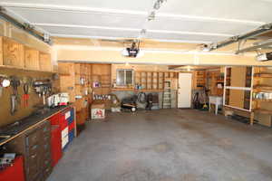 Garage with a garage door opener and a workshop area