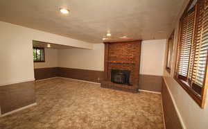 Family room with carpet and a fireplace