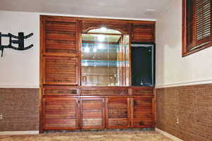 Family room with carpet and a fireplace and a wet bar