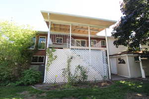 Exterior space with deck and a storage shed