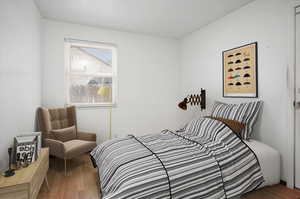 Bedroom with wood-type flooring and walk out to back yard