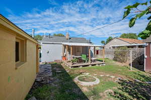 View of backyard with a deck, garage, laundry line, and shed