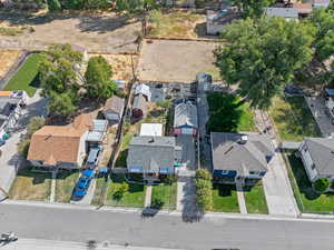 Aerial view including house, garage, back porch, greenhouse, shed, garden area