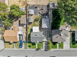 Drone / aerial view including shed, greenhouse, raised vegetable garden, house, garage,  and extended long driveway