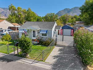 Bungalow-style house with a garage, a mountain view, and a front yard