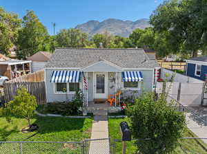 Bungalow-style house featuring a mountain view and a front yard with blackberry bushes