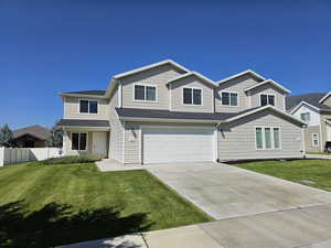 View of front of property with a front lawn and a garage