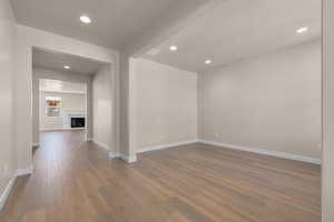 Spare room featuring a textured ceiling and wood-type flooring