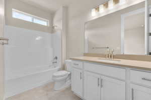 Full bathroom featuring vanity, toilet, and shower / bathing tub combination