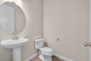 Bathroom with toilet and wood-type flooring