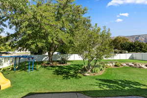 View of yard featuring a playground and a mountain view