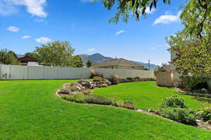 View of yard featuring a mountain view and a shed