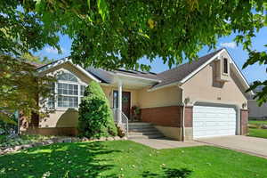 View of front of house featuring a garage and a front lawn