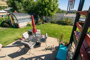 View of patio with a storage shed