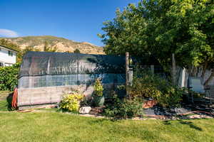 Exterior space featuring a front lawn and a mountain view