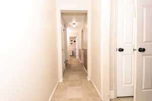 Corridor featuring light tile patterned floors