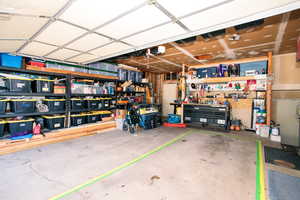 Garage with a garage door opener and a workshop area