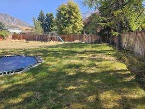 View of yard featuring a mountain view and a playground