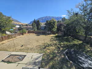 View of yard featuring a playground, a patio, and a mountain view from the master bedroom