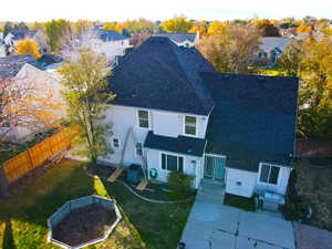 Back of property featuring a patio and a lawn