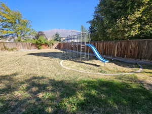 View of yard with a playground and a mountain view