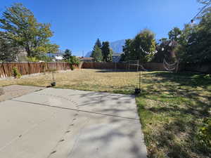 View of yard with a mountain view and a patio