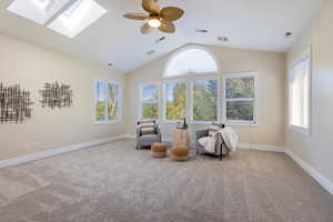 Upper level primary suite sitting room with generous amounts of natural light