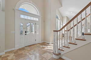 Front entry with formal living room to the south and office/flex space to the north and a grand staircase