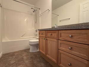 Full bathroom with bathtub / shower combination, vanity, and toilet