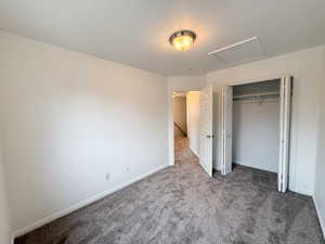 Unfurnished bedroom featuring a closet and carpet floors