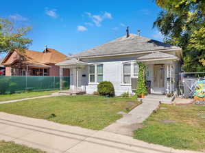 Bungalow-style house featuring a front lawn