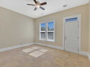 Tiled room featuring ceiling fan.