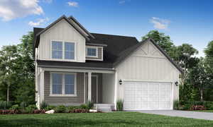 View of front facade featuring a garage, a front lawn, and covered porch