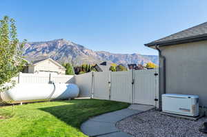 Propane fuel source for backup generator.  View of yard with a mountain view