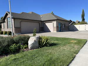 View of front facade featuring a front lawn and a garage