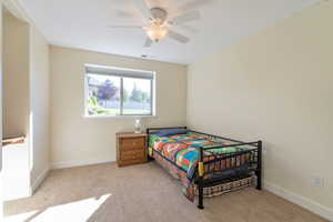 Bedroom featuring ceiling fan and light colored carpet