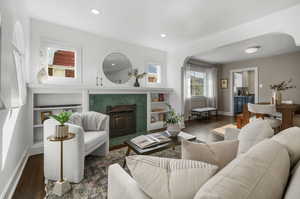 Living room featuring a vintage fireplace and built-in shelves.