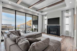 Living room featuring light hardwood / wood-style floors and beamed ceiling