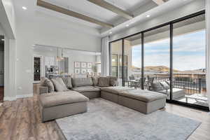 Living room featuring an inviting chandelier, light wood-type flooring, and a mountain view