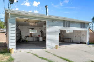 Veiw of massive 4 car garage with doors open