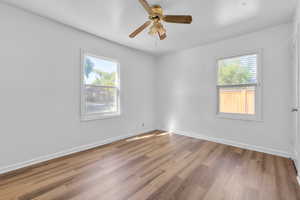 Bedroom 1 - new LVP flooring , ceiling fan, and a wealth of natural light