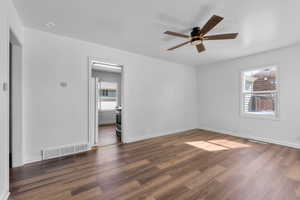 Living room into kitchen featuring ceiling fan and dark hardwood / wood-style floors