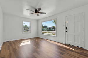 Living Room featuring ceiling fan and dark hardwood / wood-style floors