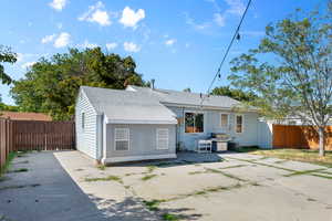 Rear view of house featuring a patio area and gated driveway